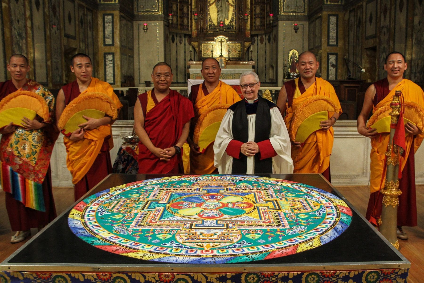The monks and Dr. Guibord with the Mandala of Compassion