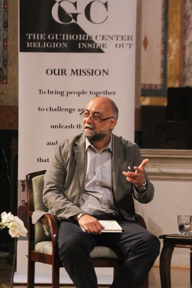 Amir Hussain with book Muslims in America 